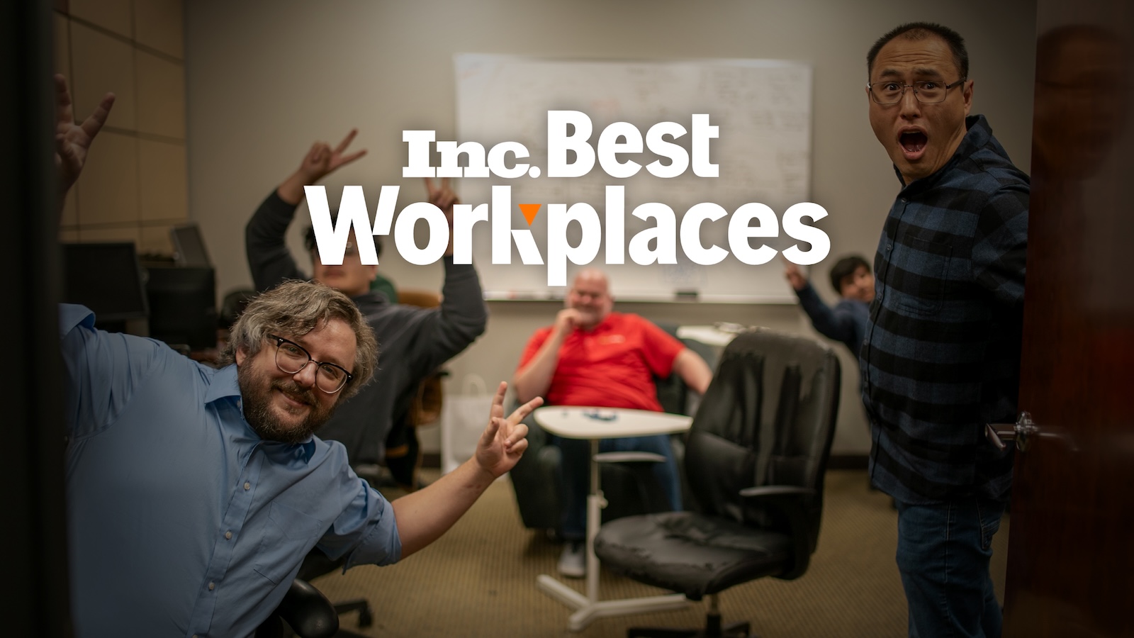 Three Pointers posing having fun in an office with the Inc. Best Workplaces logo in the foreground.