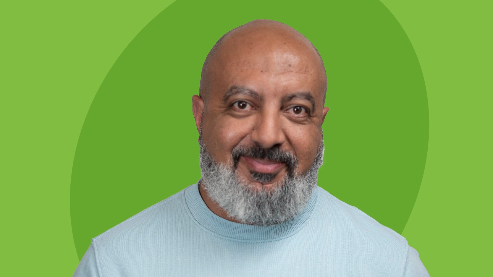 Emad Georgy headshot - a man with a clean-shaven head and a salt-and-pepper beard on a green backdrop.